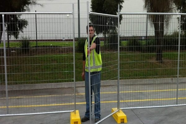 1.5m temporary fence gate installed with panels by a worker.